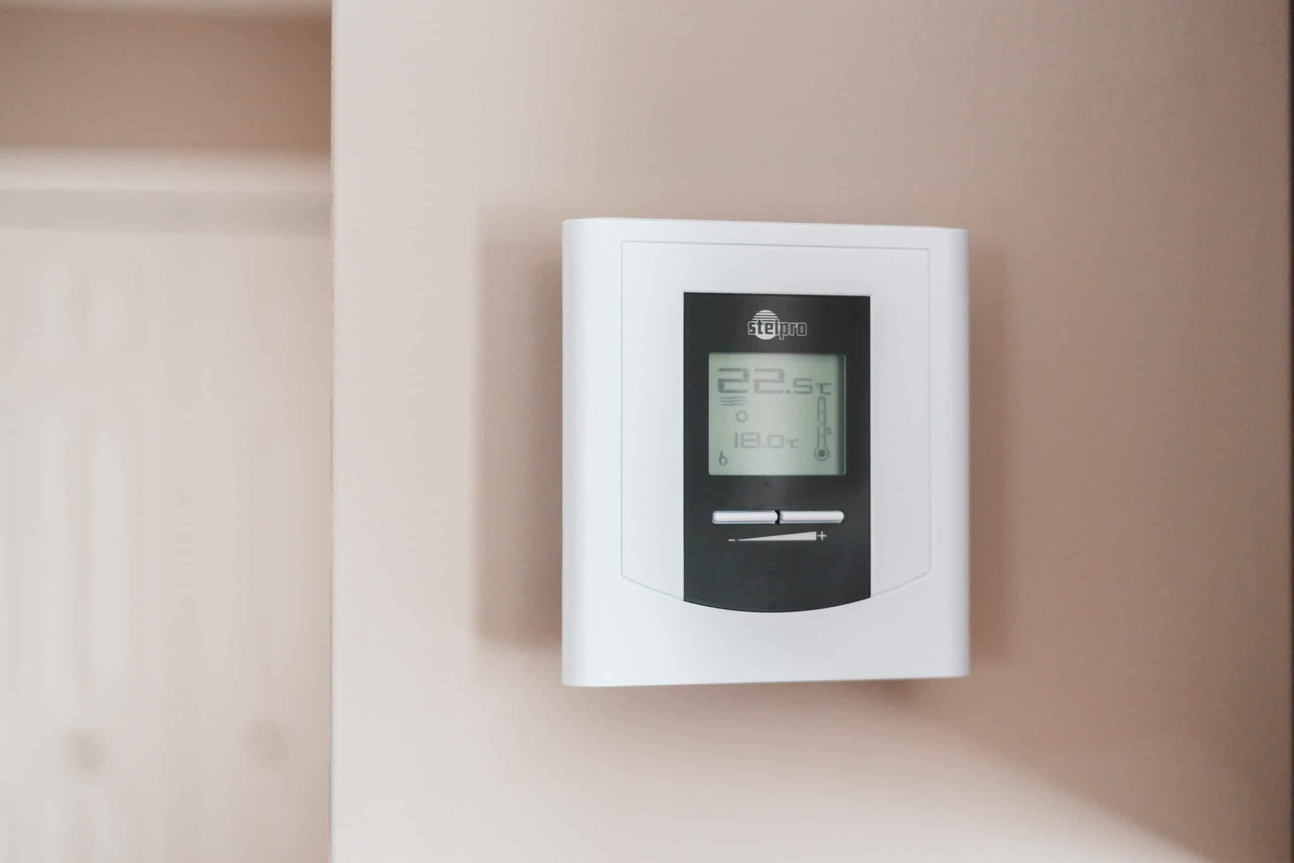 Thermostat mounted to wall